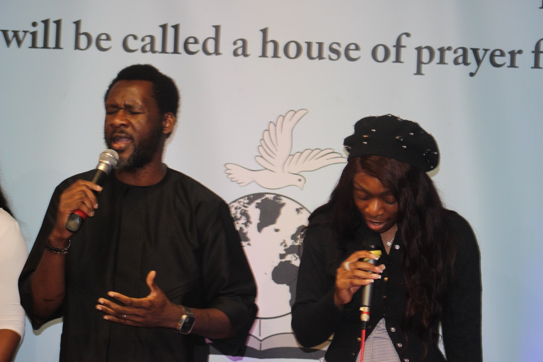 Two members of the SWPM worship team holding microphones